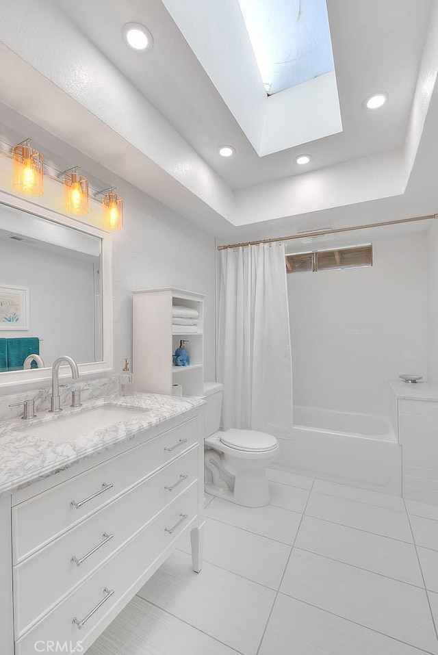 full bathroom featuring vanity, shower / tub combo, a skylight, and toilet