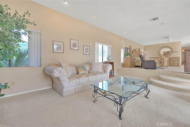 living room with light carpet and a textured ceiling