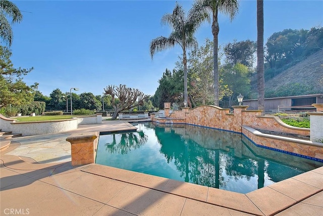 view of swimming pool featuring a patio area