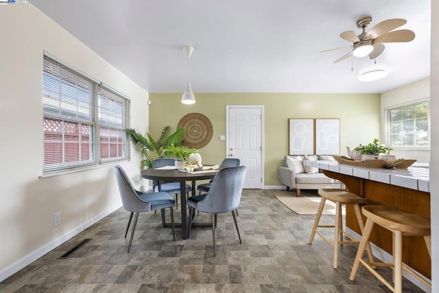 dining space featuring ceiling fan