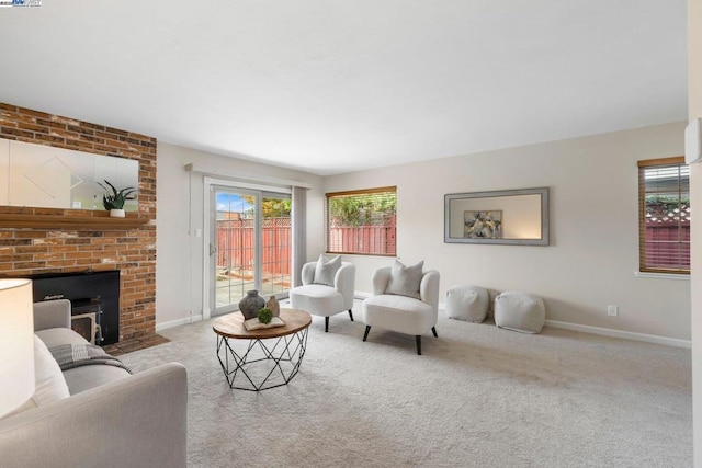 carpeted living room featuring a healthy amount of sunlight and a fireplace