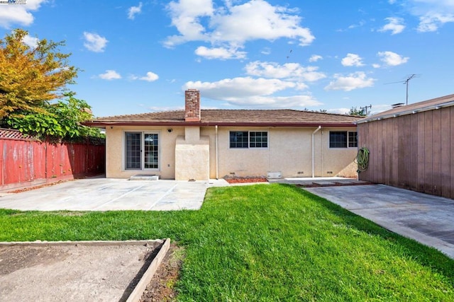 back of house with a yard and a patio area