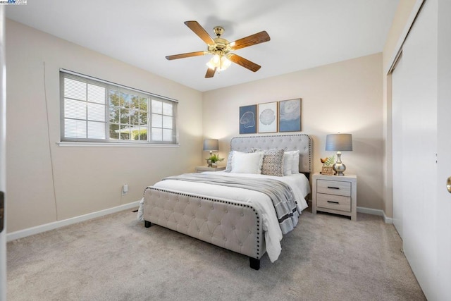 carpeted bedroom with ceiling fan and a closet