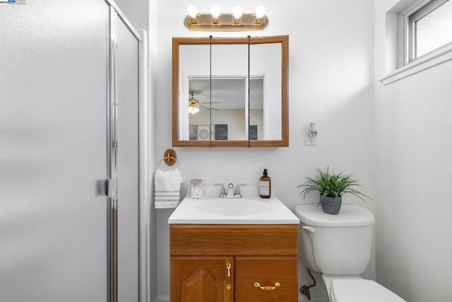 bathroom with vanity, toilet, and walk in shower