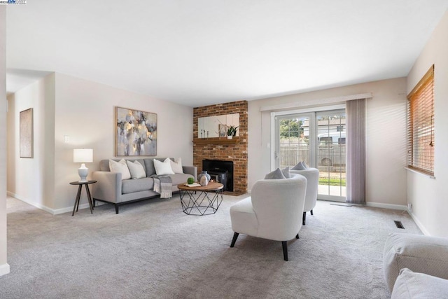 carpeted living room featuring a fireplace