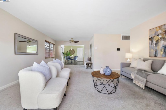 carpeted living room with ceiling fan