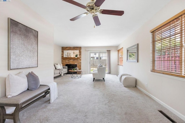 living room with carpet flooring, a fireplace, and ceiling fan