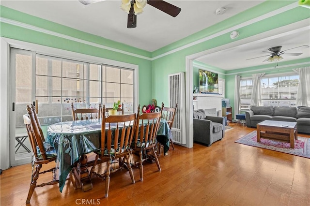 dining room featuring ornamental molding, hardwood / wood-style floors, and ceiling fan