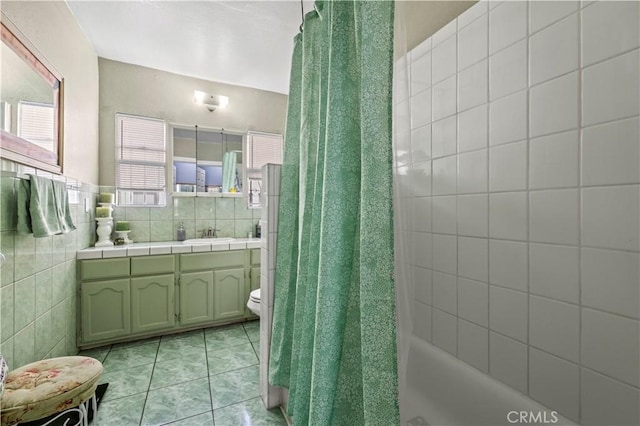 bathroom featuring vanity, toilet, tile patterned flooring, and tile walls