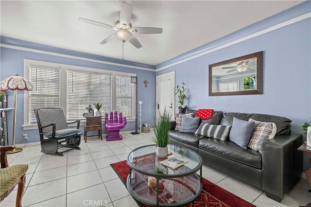 living room with crown molding, light tile patterned floors, and ceiling fan