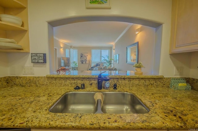 kitchen with crown molding, light brown cabinetry, sink, and light stone countertops