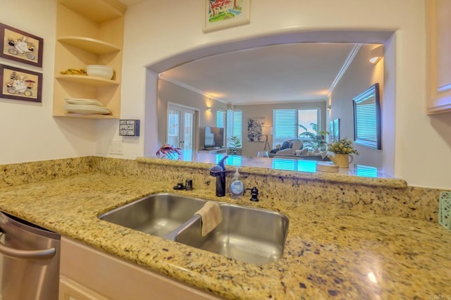 kitchen with sink, crown molding, stainless steel dishwasher, and light stone countertops