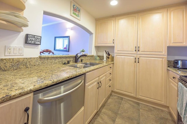 kitchen with a sink, stainless steel dishwasher, and light brown cabinetry