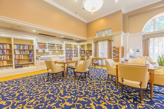 interior space with a towering ceiling and crown molding