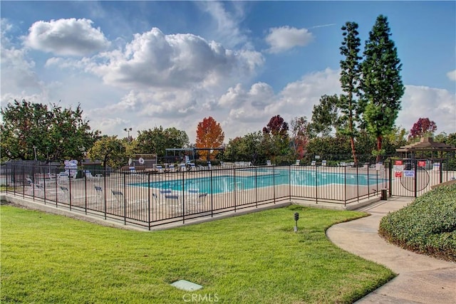 view of pool featuring a lawn