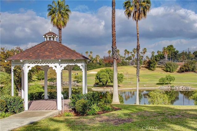 view of community with a gazebo, a lawn, and a water view