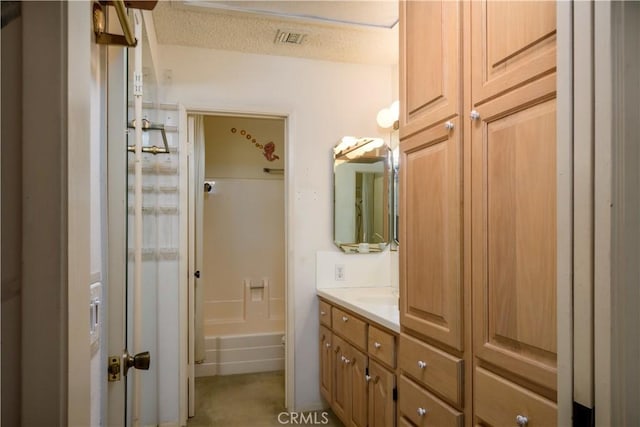 bathroom featuring vanity and a textured ceiling