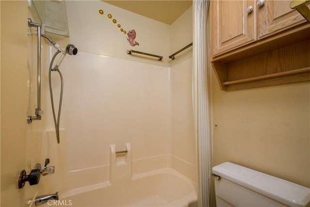 bathroom with bathtub / shower combination and toilet