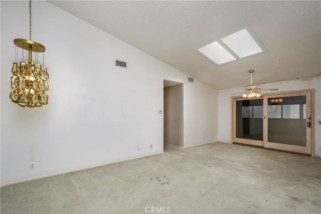 spare room featuring vaulted ceiling with skylight and light colored carpet