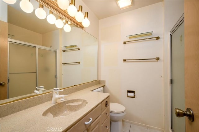 bathroom featuring vanity, tile patterned floors, toilet, and walk in shower