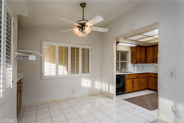 kitchen featuring sink, ceiling fan, and light tile patterned flooring