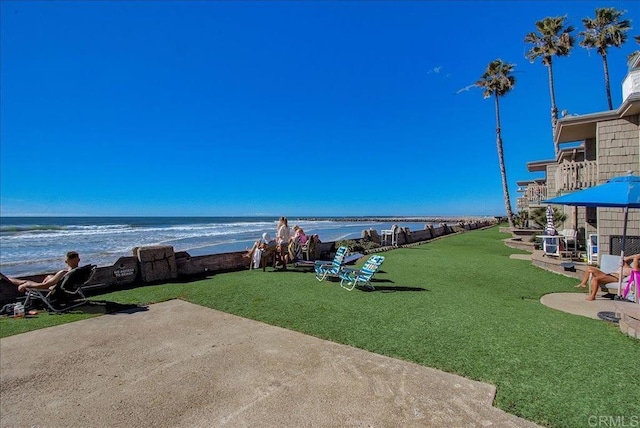 exterior space featuring a water view and a view of the beach