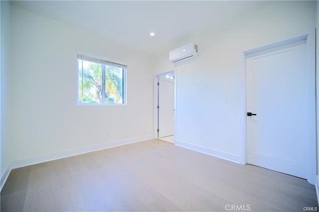 4455 S Slauson Ave, Culver City, CA 90230 - spare room featuring baseboards, light wood-style flooring, recessed lighting, and an AC wall unit