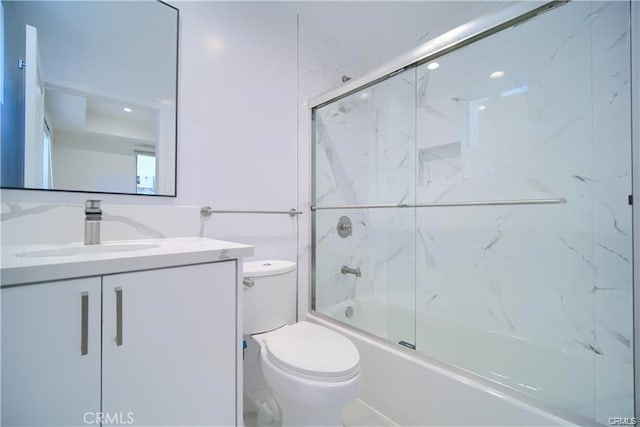 full bathroom with vanity, combined bath / shower with glass door, and toilet