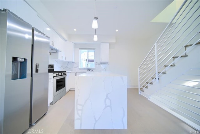 4455 S Slauson Ave, Culver City, CA 90230 - kitchen with stainless steel fridge, range with electric cooktop, white cabinets, modern cabinets, and light stone counters