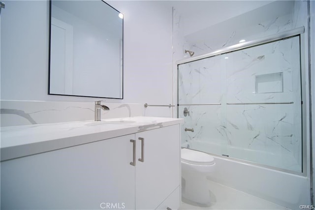 full bathroom featuring vanity, toilet, and combined bath / shower with glass door