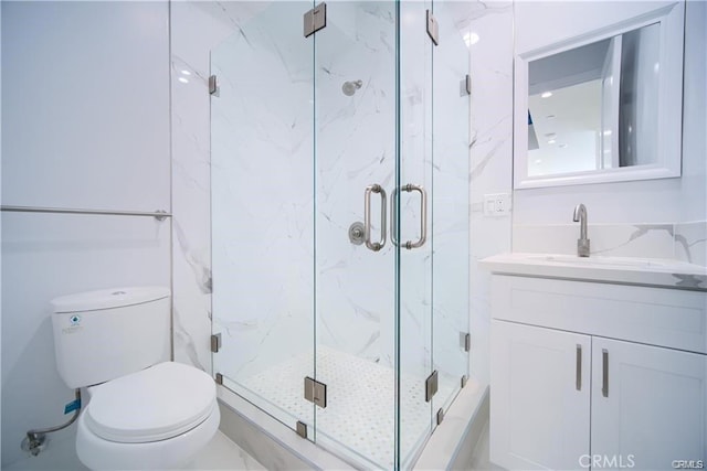 bathroom with vanity, toilet, and an enclosed shower