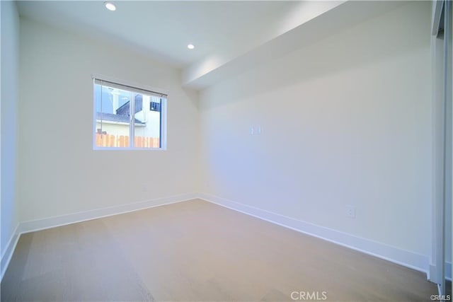 spare room with wood-type flooring