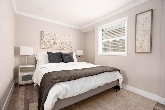 bedroom with dark wood-style flooring, crown molding, and baseboards