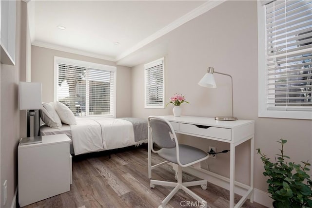 bedroom featuring crown molding and light wood finished floors