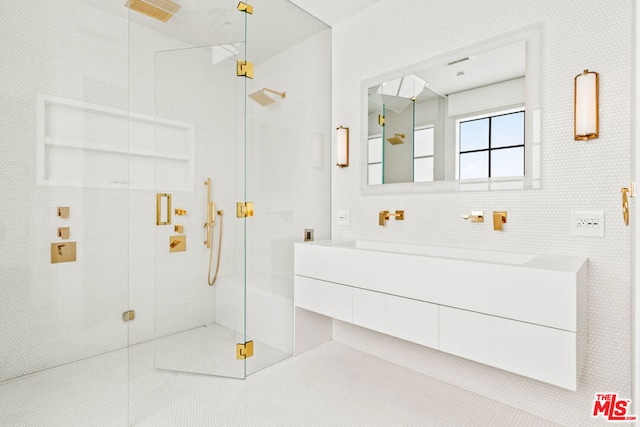 bathroom with vanity, an enclosed shower, and backsplash