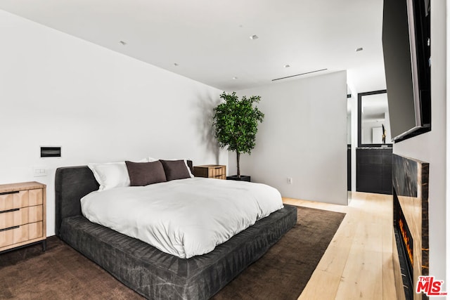 bedroom with hardwood / wood-style flooring