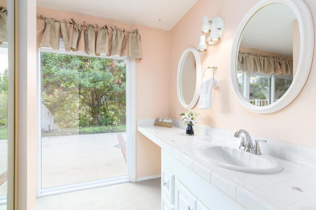 bathroom with plenty of natural light and vanity