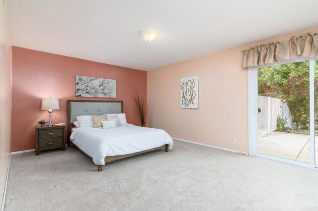 carpeted bedroom with baseboards and access to outside