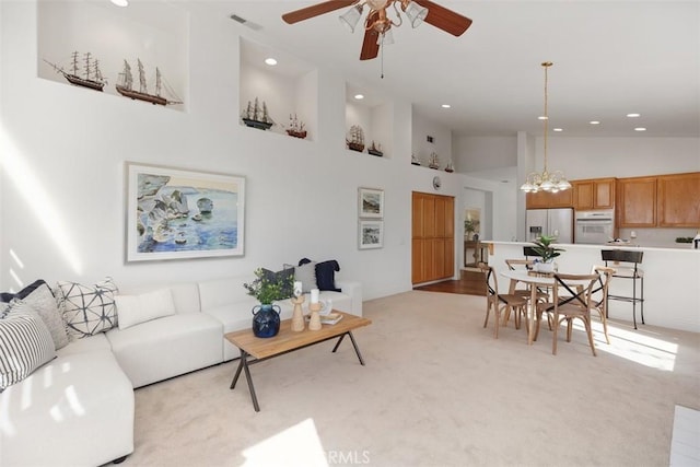 living room featuring visible vents, light colored carpet, ceiling fan, high vaulted ceiling, and recessed lighting