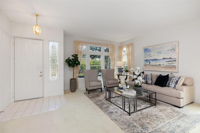 living room with baseboards, light tile patterned flooring, and light colored carpet