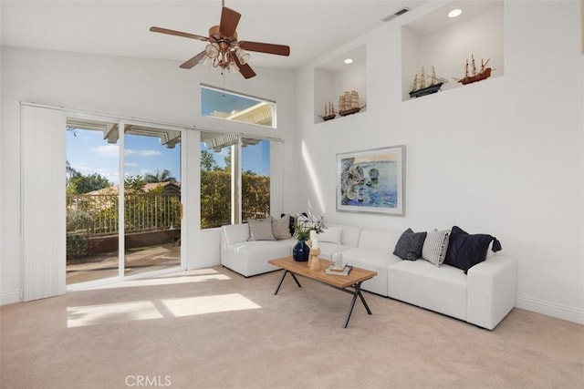 living room featuring recessed lighting, visible vents, a high ceiling, light carpet, and ceiling fan