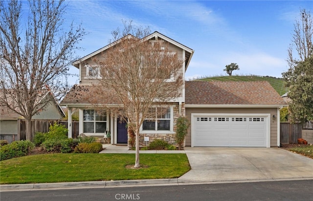 view of front of property with a garage and a front yard