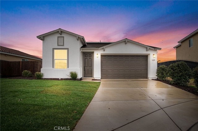 view of front of house with a garage and a lawn