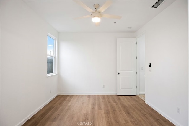 empty room featuring ceiling fan and light wood-type flooring