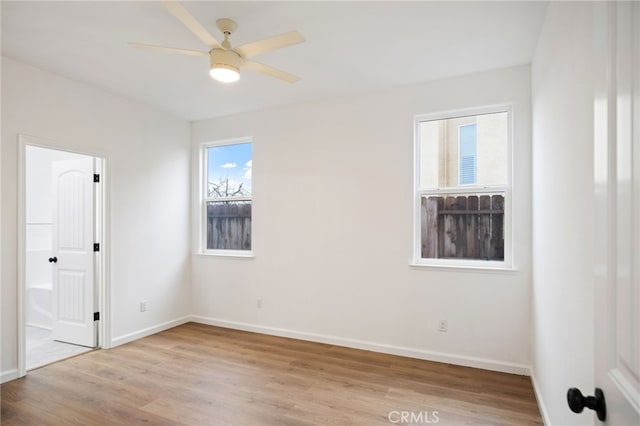 unfurnished room with ceiling fan and light wood-type flooring