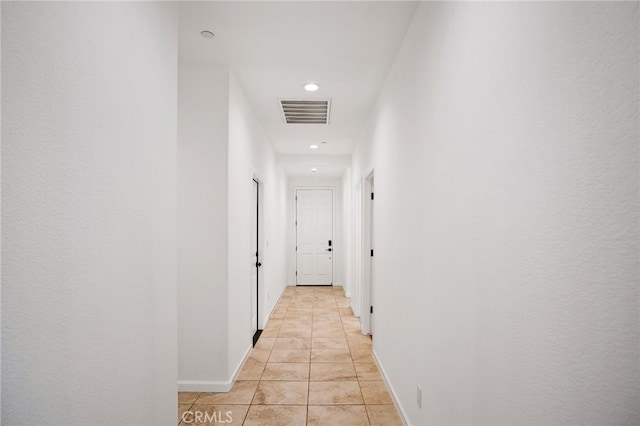 hall featuring light tile patterned floors