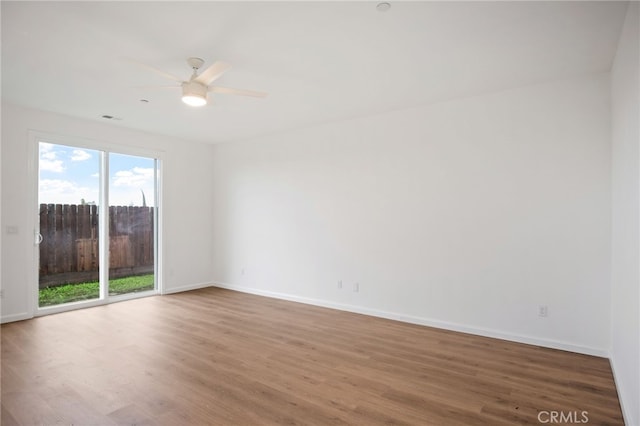 unfurnished room featuring hardwood / wood-style flooring and ceiling fan