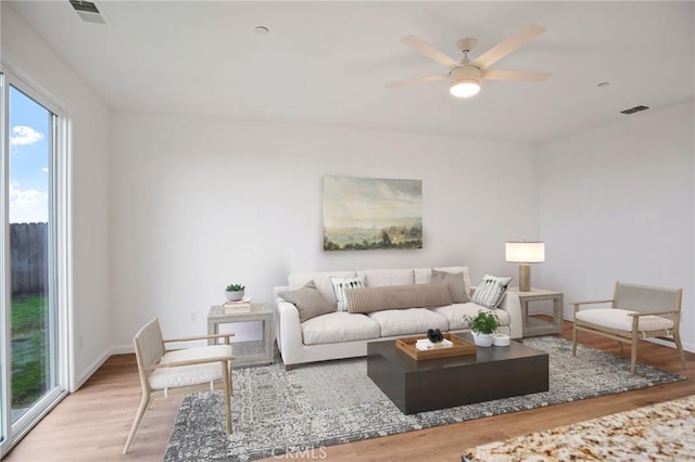 living room with ceiling fan and light wood-type flooring