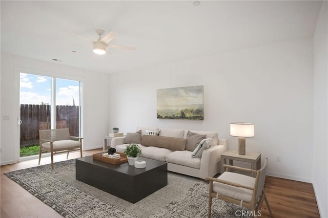 living room with hardwood / wood-style flooring and ceiling fan