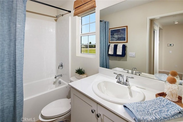 full bathroom with vanity, shower / tub combo, and toilet